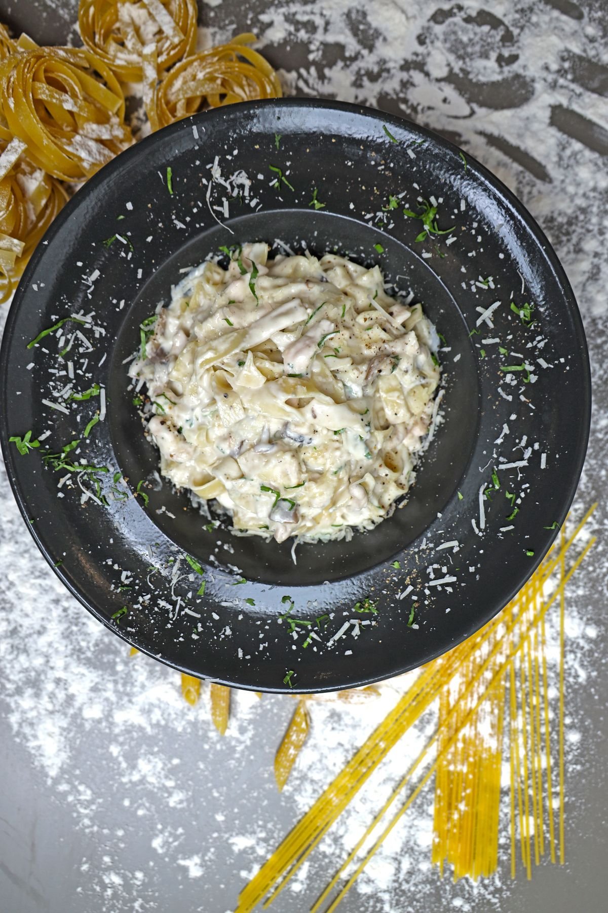 Chicken Alfredo Pasta Bake — Chicken Alfredo pasta bake with melted mozzarella and peas in a white baking dish